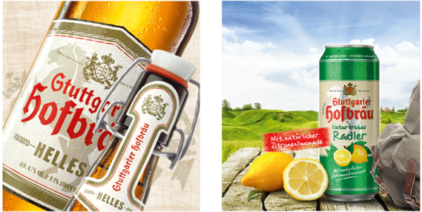 Zwei Getränkedosen stehen auf Holzbrettern vor einer hügeligen Landschaft.